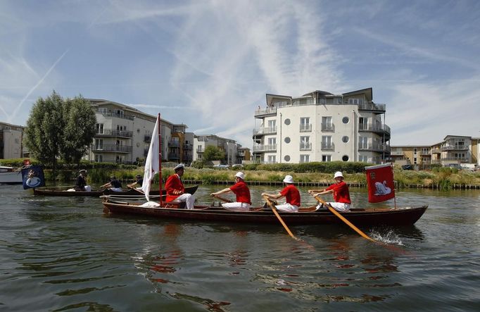 The Queen's Swan Marker David Barber (L) and the Queen's Swan Uppers look for swans and their cygnets during the annual Swan Upping ceremony on the River Thames between