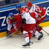 Vondrka and Novotny of the Czech Republic battle for the puck with Denmark's Lauridsen Jesper Jensen during the second period of their men's ice hockey World Championship Group A game at Chizhovka Are