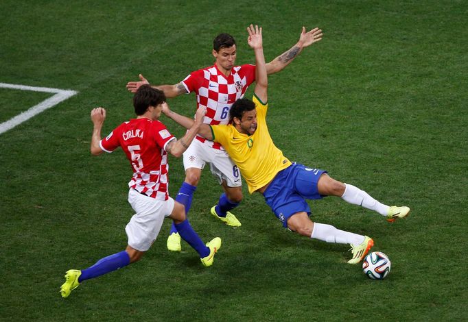 Brazil's Fred is fouled by Croatia's Dejan Lovren inside the area during their 2014 World Cup opening match at the Corinthians arena in Sao Paulo June 12, 2014. REUTERS/P