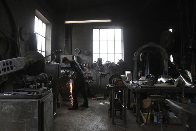 Blacksmith Johann Schmidberger works on a harness for the Vatican Swiss Guard at his workshop in Molln, Upper Austria June 12, 2012. Blacksmith brothers Johann, 29, and Georg, 28, produce made-to-order handmade harnesses for the Vatican, which take 120 hours of handiwork per piece and hardly differs from the 500-year-old originals. The brothers carry on the tradition of the blacksmith trade in the fifth generation of their family. REUTERS/Lisi Niesner (AUSTRIA - Tags: SOCIETY MILITARY) Published: Čer. 12, 2012, 10:20 odp.