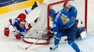 Russia's Sergei Plotinikov tries to score past Kazakhstan's Roman Starchenko and goalie Alexei Ivanov (L-R) during the first period of their men's ice hockey World Champi