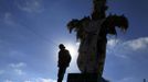 Marathon runner Gladys Tejeda, the first Peruvian athlete who qualified for the 2012 London Olympic Games, stands next to a cross before training at the San Cristobal mountain in the Andean province of Junin May 15, 2012. A private company will take Gladys' mother Marcelina Pucuhuaranga, 69, to London as part of the "Thank you Mom" program. For Pucuhuaranga, who received her first passport, it will be the first time travelling out of Peru. The program will take about 120 mothers of different athletes around the world to attend the games. Tejeda, the youngest of nine children, returned to her hometown to visit her mother and to focus on training where she will run more than 20 km every day in the highlands (over 4,105 meters above sea level). Picture taken May 15, 2012. REUTERS/Pilar Olivares(PERU - Tags: SPORT ATHLETICS OLYMPICS) Published: Kvě. 17, 2012, 6:25 odp.