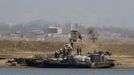 People transport packs of rice at Hwanggumpyong Island located in the middle of the Yalu River, near the North Korean town of Sinuiju and the Chinese border city of Dandong, March 29, 2013. China called for an easing of tensions on Friday as North Korea put its missile units on standby to attack U.S. military bases in South Korea and the Pacific after the United States flew two nuclear-capable stealth bombers over the Korean peninsula. REUTERS/Jacky Chen