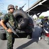 Thai soldiers take up a position on a main road in Bangkok