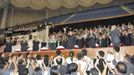 North Korean leader Kim waves next to his wife Ri as guests applaud during the 2013 Asian Cup and Interclub Junior and Senior Weightlifting Championship in Pyongyang