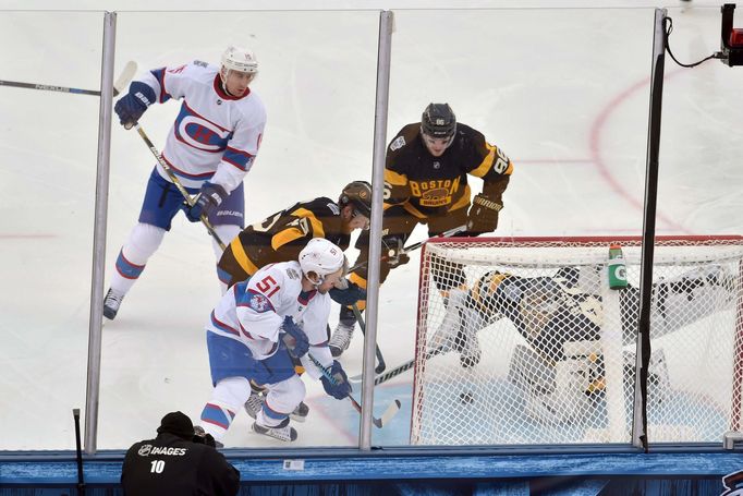 Montreal Canadiens center David Desharnais (51) scores on Boston Bruins goalie Tuukka Rask (40) in front of Bruins defenseman Kevan Miller (86) and Joe Morrow (45)