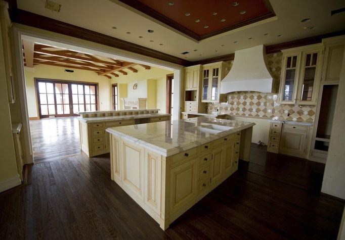 The kitchen of a for sale, $37 million dollar luxury home at One Pelican Hill Road North is seen in Newport Beach, California April 13, 2012. It has 17 bathrooms, a 17-car garage, marbled floors, gold leaf ceilings, a vineyard, horse stables, tennis courts and a lake - and occupies the largest parcel of residential real estate on southern California's exclusive Newport Coast. This empty, never-sold, soon-to-be-auctioned mega-mansion is a gaudy symbol of the runaway extravagance that gripped the top end of the U.S. real estate market before the housing crash of 2008. Once valued at $87 million, it could be sold for a quarter of that price at an auction next week. Picture taken April 13, 2012. REUTERS/Lori Shepler (UNITED STATES - Tags: REAL ESTATE BUSINESS)