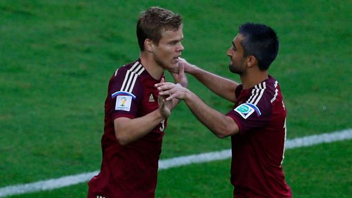 Russia's Alexander Kokorin (L) celebrates with teammate Alexander Samedov after scoring a goal against Algeria during their 2014 World Cup Group H soccer match at the Bai