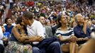 July 16, 2012 "The President and First Lady were attending the game between the U.S. Men's Olympic basketball team and Brazil in Washington, D.C. During the first half, the jumbotron flashed couples on their 'Kiss Cam', where they are then induced by the crowd to kiss each other. But neither the President or First Lady saw themselves when they were flashed on the 'Kiss Cam', and some in the audience booed when they didn't kiss. At halftime, as we walked to the locker room to visit the U.S. team, daughters Malia and Sasha were asking their parents why they hadn't kissed during their 'Kiss Cam' moment. Both the President and First Lady said they hadn't even realized what had happened and didn't know why people were booing. So in the second half, when they appeared again on the 'Kiss Cam', the President leaned over to kiss the First Lady amidst audience cheers as Malia and the Vice President watched overhead on the jumbotron."