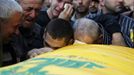 RNPS IMAGES OF THE YEAR 2012 - Relatives mourn over the coffin of a Hezbollah member during his funeral in Sehmor village, in West Bekaa October 4, 2012. Three members of the Shi'ite Muslim militant group Hezbollah were killed on Wednesday when an explosion ripped through a weapons warehouse in eastern Lebanon, the group said. REUTERS/Mohamed Azakir (LEBANON - Tags: POLITICS CIVIL UNREST) Published: Pro. 4, 2012, 1:08 dop.