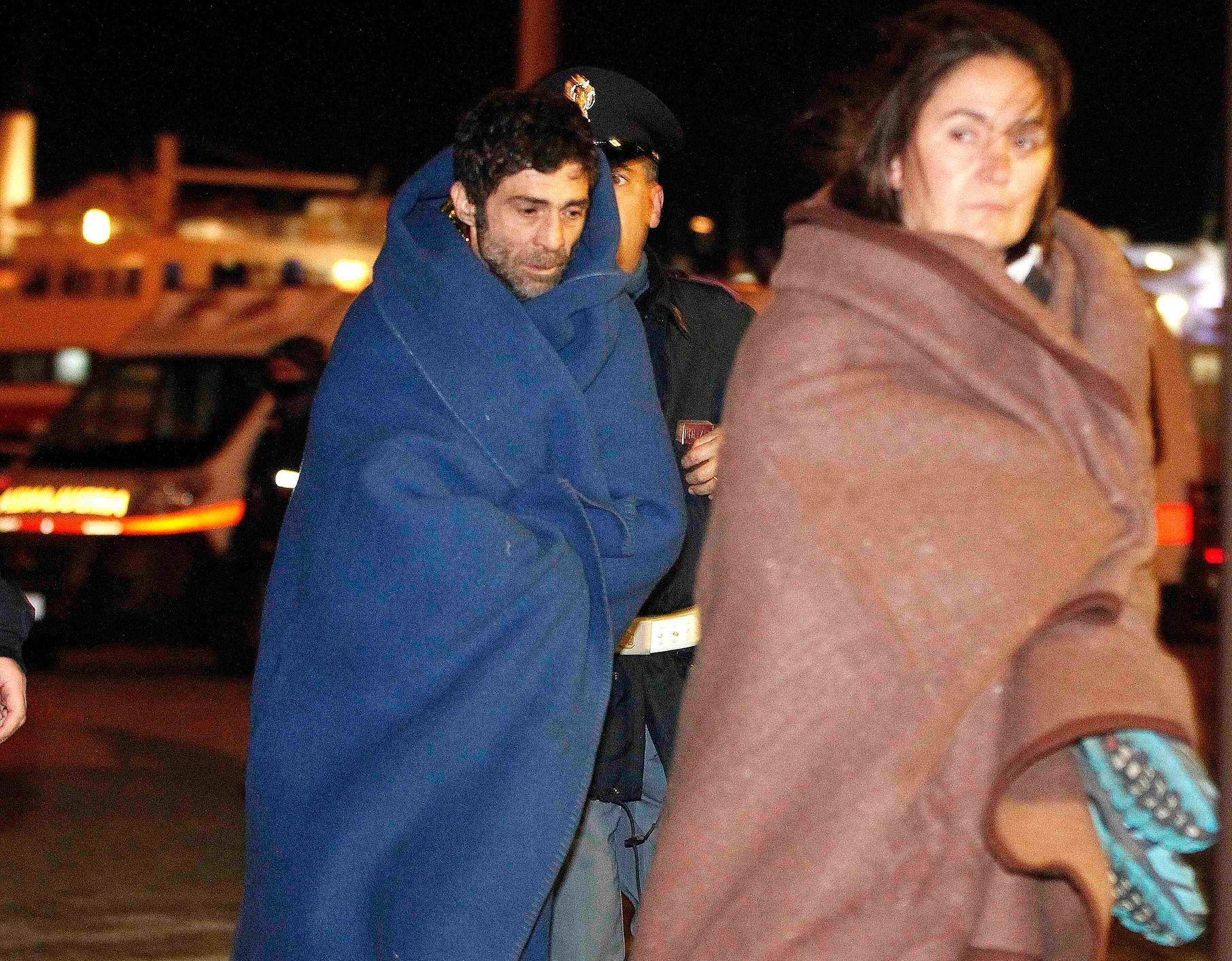 Survivors from the car ferry Norman Atlantic leave the Italian Navy San Giorgio amphibious transport ship in the Brindisi