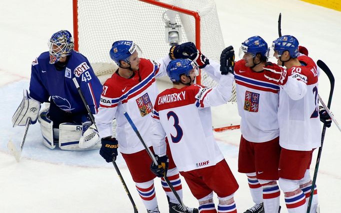 Jan Kolar of the Czech Republic (R) celebrates his goal with team mates as France's goalie Florian Hardy (L) reacts during the overtime period of their men's ice hockey W