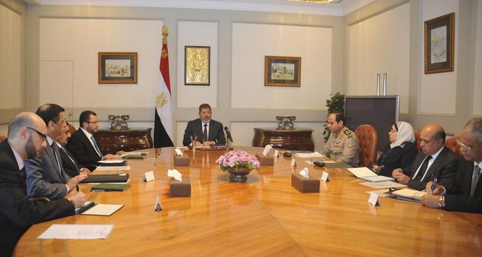 Egypt's President Mohamed Mursi (C) meets with Egypt's Prime Minister Hisham Kandil (L) and defence minister Abdel Fattah al-Sissi (R) at the presidential palace in Cairo November 15, 2012. Mursi condemned Israeli air strikes on the Gaza Strip as unacceptable on Thursday, in his harshest public criticism of Egypt's neighbour since taking office in June. REUTERS/Egyptian Presidency/Handout (EGYPT - Tags: POLITICS) FOR EDITORIAL USE ONLY. NOT FOR SALE FOR MARKETING OR ADVERTISING CAMPAIGNS. THIS IMAGE HAS BEEN SUPPLIED BY A THIRD PARTY. IT IS DISTRIBUTED, EXACTLY AS RECEIVED BY REUTERS, AS A SERVICE TO CLIENTS Published: Lis. 15, 2012, 3:23 odp.