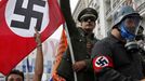 Demonstrators, dressed as Nazis, wave a Greek and a swastika flag as they ride in an open-top car in Syntagma Square in Athens as they protest against the visit of Germany's Chancellor Angela Merkel, October 9, 2012. Germany's Angela Merkel arrived in Greece on her first visit since Europe's debt crisis erupted here three years ago, braving protests to deliver a message of support - but no new money - to a nation hammered by recession and fighting to stay in the euro. REUTERS/Yannis Behrakis (GREECE - Tags: POLITICS BUSINESS) Published: Říj. 9, 2012, 12:38 odp.