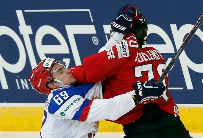 Russia's Alexander Burmistrov (L) clashes with Switzerland's Denis Hollenstein (R) during their men's ice hockey World Championship Group B game at Minsk Arena in Minsk M