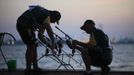 Jan Tolmay and Wessel Fouche (R) of South Africa check their rods during the 14th Carpfishing World Championship in Corbu village, 310 km (192 miles) east of Bucharest, September 28, 2012. REUTERS/Radu Sigheti (ROMANIA - Tags: SPORT SOCIETY) Published: Zář. 28, 2012, 8:05 odp.