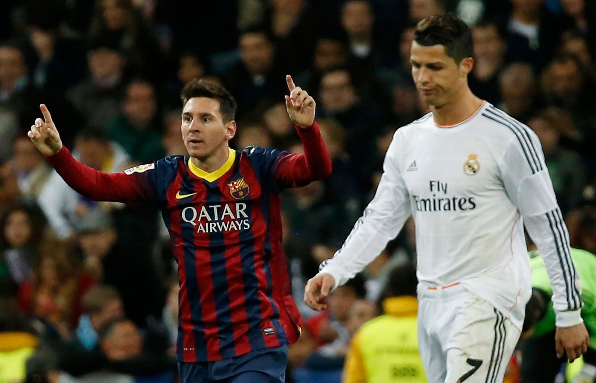Barcelona's Lionel Messi celebrates a goal next to Real Madrid's Cristiano Ronaldo during La Liga's second 'Clasico' soccer match of the season in Madrid