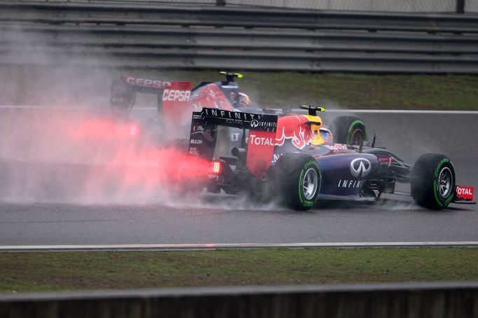 Red Bull Racing Formula One driver Daniel Ricciardo of Australia (R) and Toro Rosso Formula One driver Daniil Kvyat of Russia drive during the third practice session of t