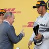 Russian President Putin gives a thumbs up to the winner Mercedes Formula One driver Hamilton of Britain after the first Russian Grand Prix in Sochi