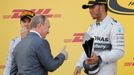 Russian President Vladimir Putin gives a thumbs up to the winner Mercedes Formula One driver Lewis Hamilton of Britain as Mercedes Formula One driver Nico Rosberg of Germ