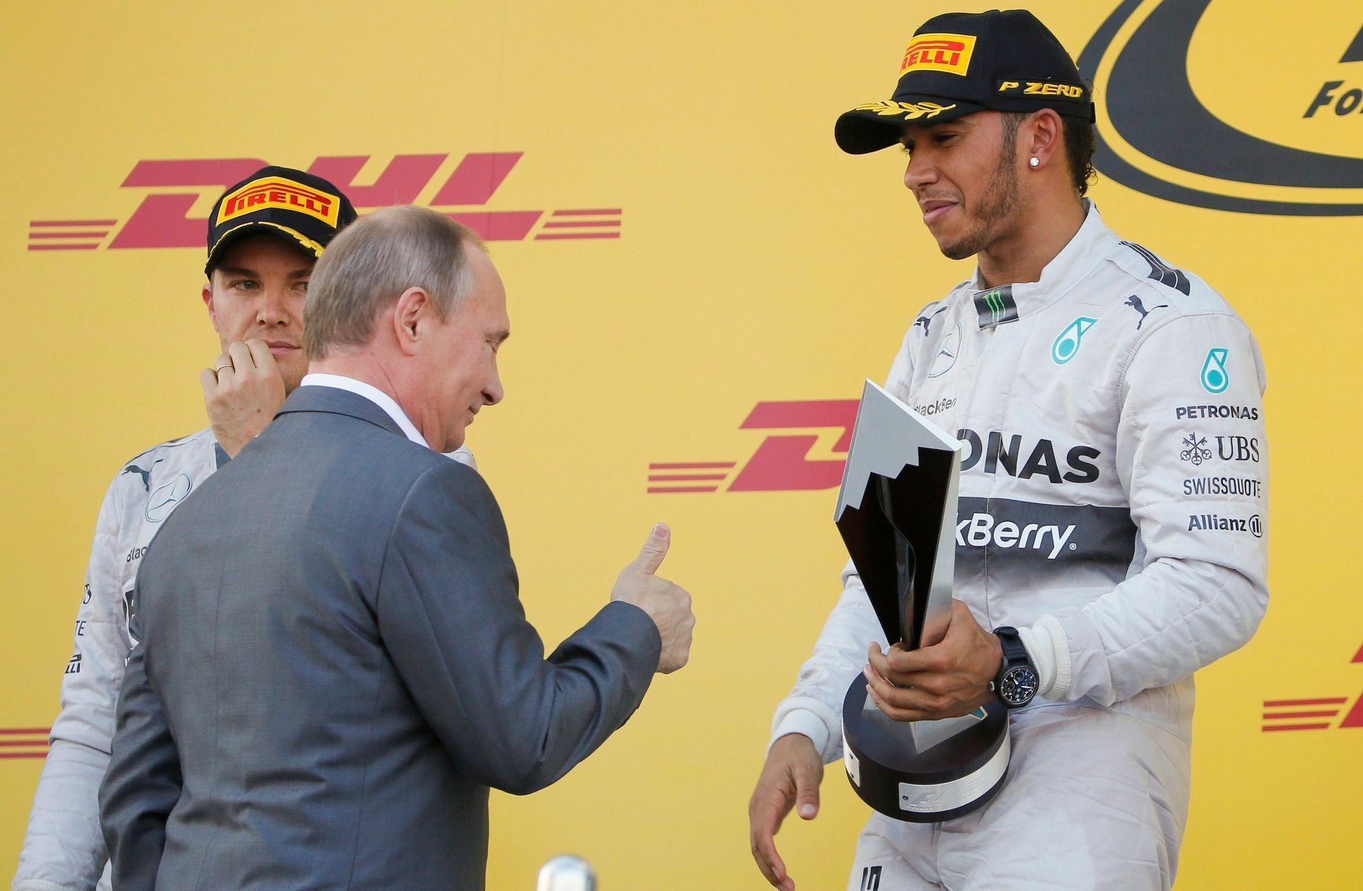 Russian President Putin gives a thumbs up to the winner Mercedes Formula One driver Hamilton of Britain after the first Russian Grand Prix in Sochi