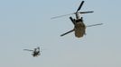 Britain's Prince Harry flies his Apache helicopter (L) as an escort for a Chinook helicopter from Camp Bastion, southern Afghanistan in this photograph taken November 1, 2012, and released January 21, 2013. The Prince, who is serving as a pilot/gunner with 662 Squadron Army Air Corps, is on a posting to Afghanistan that runs from September 2012 to January 2013. Photograph taken November 1, 2012. REUTERS/John Stillwell/Pool (AFGHANISTAN - Tags: MILITARY POLITICS SOCIETY ROYALS CONFLICT) Published: Led. 21, 2013, 7:55 odp.