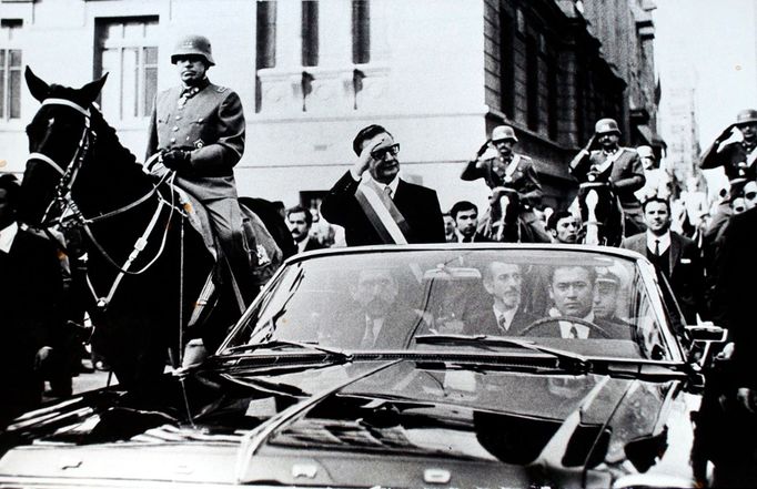 FILE - Chilean President Salvador Allende salutes from an open vehicle as General Augusto Pinochet rides on horseback at left in Santiago, Chile, May 21, 1972. (AP Photo/