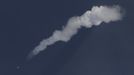 The Long March II-F rocket (bottom L) loaded with a Shenzhou-9 manned spacecraft carrying Chinese astronauts Jing Haipeng, Liu Wang and Liu Yang is seen with its smoke in the sky over the Jiuquan Satellite Launch Center, Gansu province June 16, 2012. China launched the spacecraft putting its first woman, 33-year-old female fighter pilot Liu Yang, in orbit on Saturday as the country takes its latest step towards building a space station within the decade. REUTERS/Jason Lee (CHINA - Tags: MILITARY SCIENCE TECHNOLOGY) Published: Čer. 16, 2012, 11:57 dop.