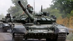 FILE PHOTO: Service members of pro-Russian troops drive tanks in the course of Ukraine-Russia conflict near the settlement of Olenivka