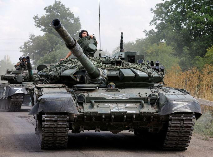 FILE PHOTO: Service members of pro-Russian troops drive tanks in the course of Ukraine-Russia conflict near the settlement of Olenivka in the Donetsk region, Ukraine July