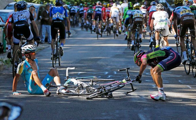 Astana team rider Michele Scarponi of Italy and Lampre-Merida team rider Jose Rodolfo Serpa of Colombia recover after crashing during the 187.5-km 11th stage of the Tour