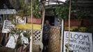 Peter Norton, 63, walks out of his trailer covered in protest signs in Village Trailer Park in Santa Monica, California, July 13, 2012. Developer Marc Luzzatto wants to relocate residents from the trailer park to make way for 486 residential units, 8,650 square feet of creative or office space, 17,780 square feet of retail, cafes and yoga studios, close to where a light rail line is being built to connect downtown Los Angeles to the ocean. Village Trailer Park was built in 1951, and 90 percent of its residents are elderly, disabled or both, according to the LA Weekly. Many have lived there for decades in old trailers which they bought. The property is valued at as much as $30 million, according the LA Times. REUTERS/Lucy Nicholson (UNITED STATES - Tags: SOCIETY REAL ESTATE BUSINESS POLITICS) Published: Čec. 14, 2012, 8:01 dop.