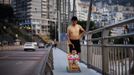 A man walks with his son on a bridge over the Yangtze River in Badong city, 100km (62 miles) from the Three Gorges dam in Hubei province in this August 8, 2012 file photo. China relocated 1.3 million people during the 17 years it took to complete the Three Gorges dam. Even after finishing the $59 billion project last month, the threat of landslides along the dam's banks will force tens of thousands to move again. It's a reminder of the social and environmental challenges that have dogged the world's largest hydroelectric project. While there has been little protest among residents who will be relocated a second time, the environmental fallout over other big investments in China has become a hot-button issue ahead of a leadership transition this year. Picture taken on August 8, 2012. To match story CHINA-THREEGORGES/ REUTERS/Carlos Barria/Files (CHINA - Tags: POLITICS ENVIRONMENT BUSINESS ENERGY) Published: Srp. 22, 2012, 8:36 odp.