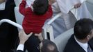 Pope Francis kisses a child as he arrives in Saint Peter's Square for his inaugural mass at the Vatican, March 19, 2013. Pope Francis celebrates his inaugural mass on Tuesday among political and religious leaders from around the world and amid a wave of hope for a renewal of the scandal-plagued Roman Catholic Church. REUTERS/Tony Gentile (VATICAN - Tags: RELIGION POLITICS) Published: Bře. 19, 2013, 8:30 dop.