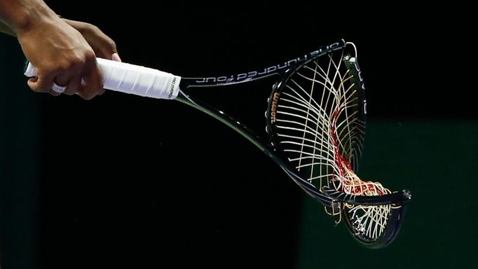 Serena Williams of the U.S. walks off the court with her broken racquet during her WTA Finals singles semi-final tennis match against Caroline Wozniacki of Denmark at the