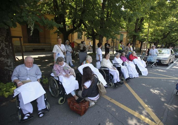 People wait outside a hospital after an earthquake in Crevalcore near Modena