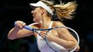 Maria Sharapova of Russia hits a return to Petra Kvitova of the Czech Republic during their WTA Finals singles tennis match at the Singapore Indoor Stadium October 23, 20