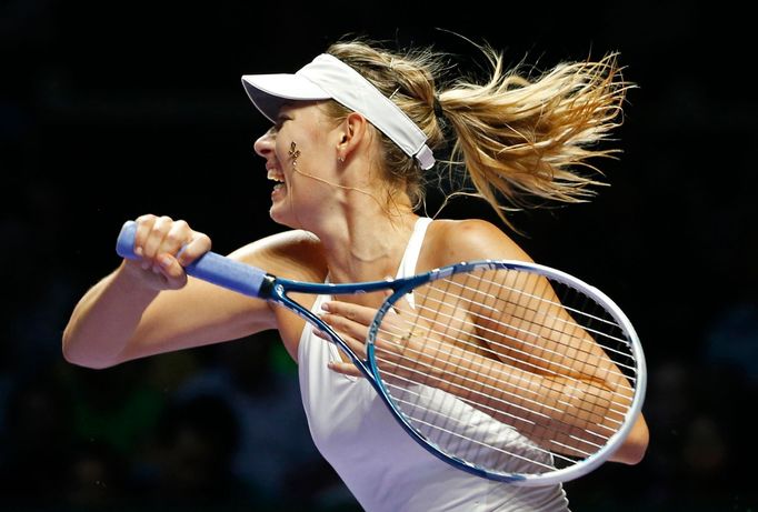 Maria Sharapova of Russia hits a return to Petra Kvitova of the Czech Republic during their WTA Finals singles tennis match at the Singapore Indoor Stadium October 23, 20