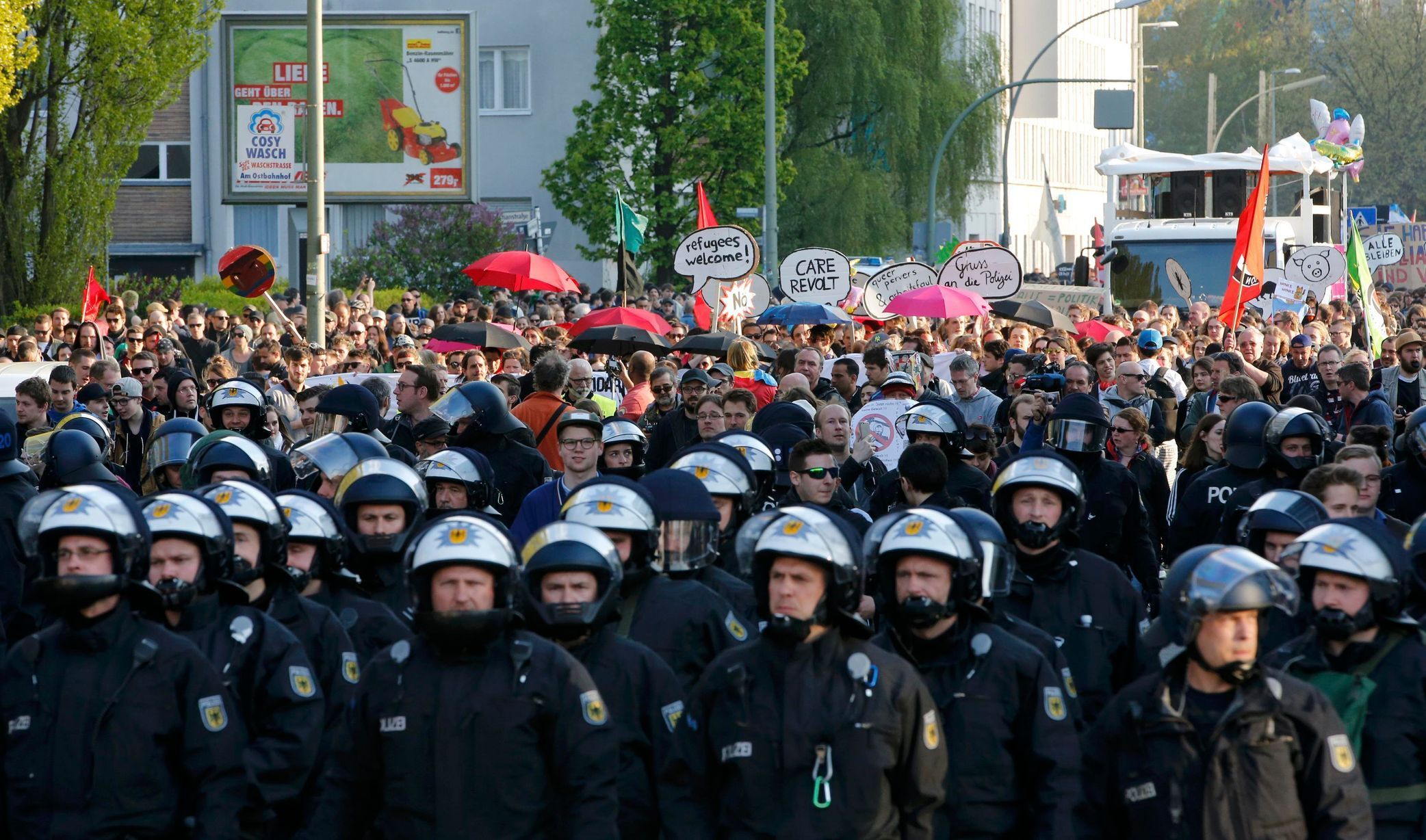 German police officers secure people walking during a May Day march through Berlin's Kreuzberg district