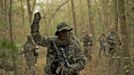 A member of the North Florida Survival Group carries an AR-15 rifle as he takes the point position in performing enemy contact drills during a field training exercise in Old Town, Florida, December 8, 2012. The group trains children and adults alike to handle weapons and survive in the wild. The group passionately supports the right of U.S. citizens to bear arms and its website states that it aims to teach "patriots to survive in order to protect and defend our Constitution against all enemy threats". Picture taken December 8, 2013. REUTERS/Brian Blanco (UNITED STATES - Tags: SOCIETY POLITICS) ATTENTION EDITORS: PICTURE 11 OF 20 FOR PACKAGE 'TRAINING CHILD SURVIVALISTS' SEARCH 'FLORIDA SURVIVAL' FOR ALL IMAGES Published: Úno. 22, 2013, 1 odp.