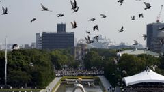 Doves fly over Peace Memorial Park with Atomic Bomb Dome in the background, at a ceremony in Hiroshima