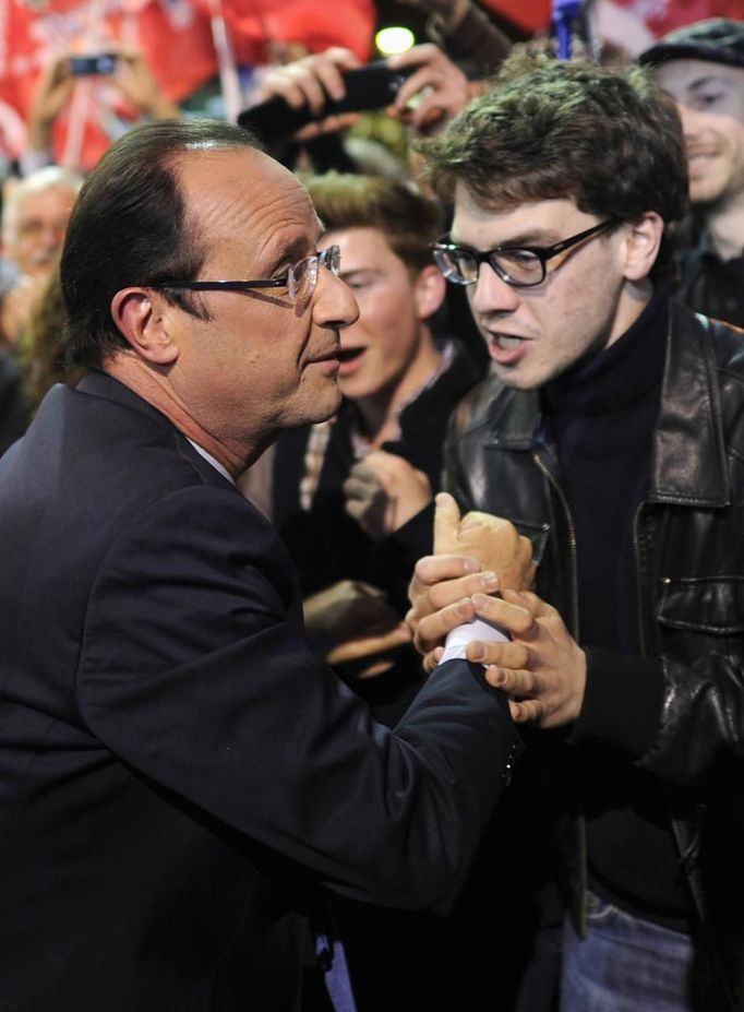 Hollande, Socialist Party candidate for the 2012 French presidential election, arrives at a campaign rally in Rennes