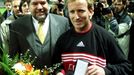 FILE PHOTO: Prime minister of Rheinland-Pfalz Kurt Beck (L) gives a medal to German soccer player Andreas Brehme of 1. FC Kaiserslautern before the farewell match in Kais