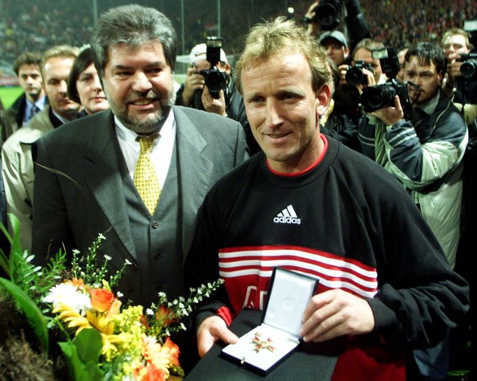 FILE PHOTO: Prime minister of Rheinland-Pfalz Kurt Beck (L) gives a medal to German soccer player Andreas Brehme of 1. FC Kaiserslautern before the farewell match in Kais