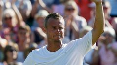Lleyton Hewitt of Australia gestures to the crowd after losing his match against Jarkko Nieminen of Finland at the Wimbledon Tennis Championships in London