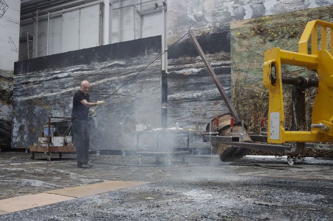 Anselm Kiefer lije olovo na svou malbu v ateliéru na pařížském předměstí.