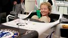 Swiss Finance Minister Eveline Widmer-Schlumpf smiles as she sits in a C31 Formula One race car of Sauber Formula One Team at the teams headquarters in the town of Hinwil