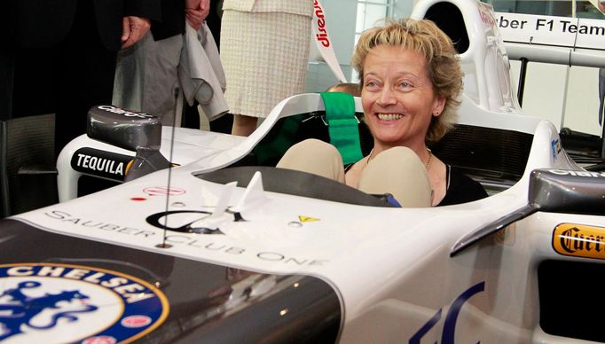 Swiss Finance Minister Eveline Widmer-Schlumpf smiles as she sits in a C31 Formula One race car of Sauber Formula One Team at the teams headquarters in the town of Hinwil