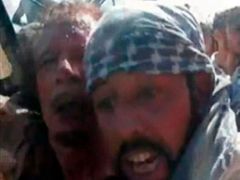 Umírajícího Kaddáfího vytahují povstalci z pick-upu, kterým ho vezli k Misurátě