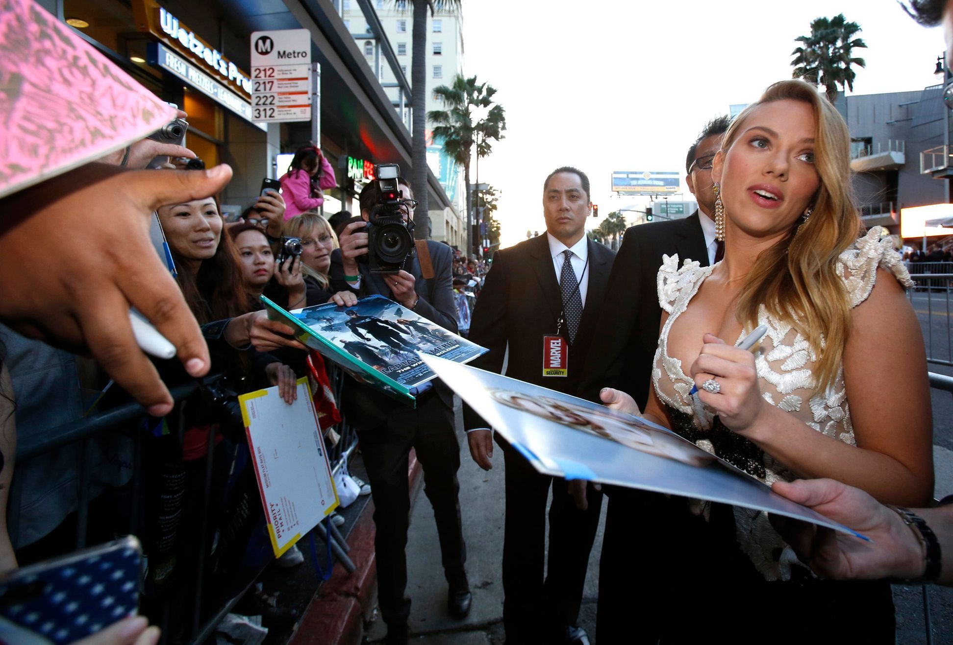 Cast member Johansson signs autographs at the premiere of &quot;Captain America: The Winter Soldier&quot; at El Capitan theatre in Hollywood